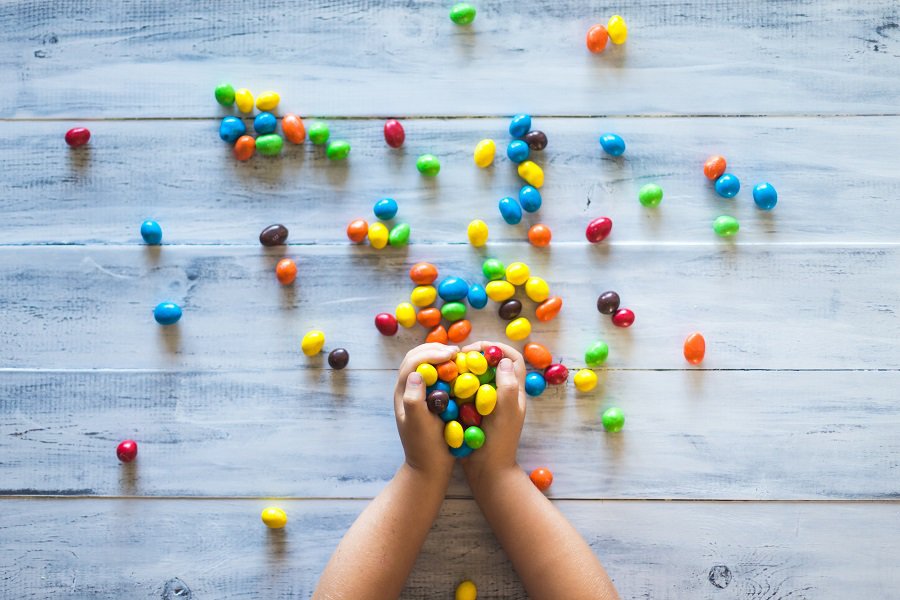 kids' hands with colourful candy