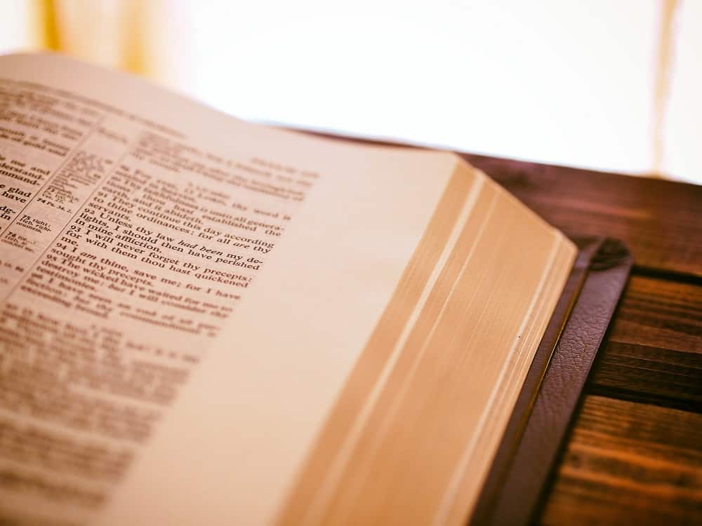 Bible on a wooden table in sunlight