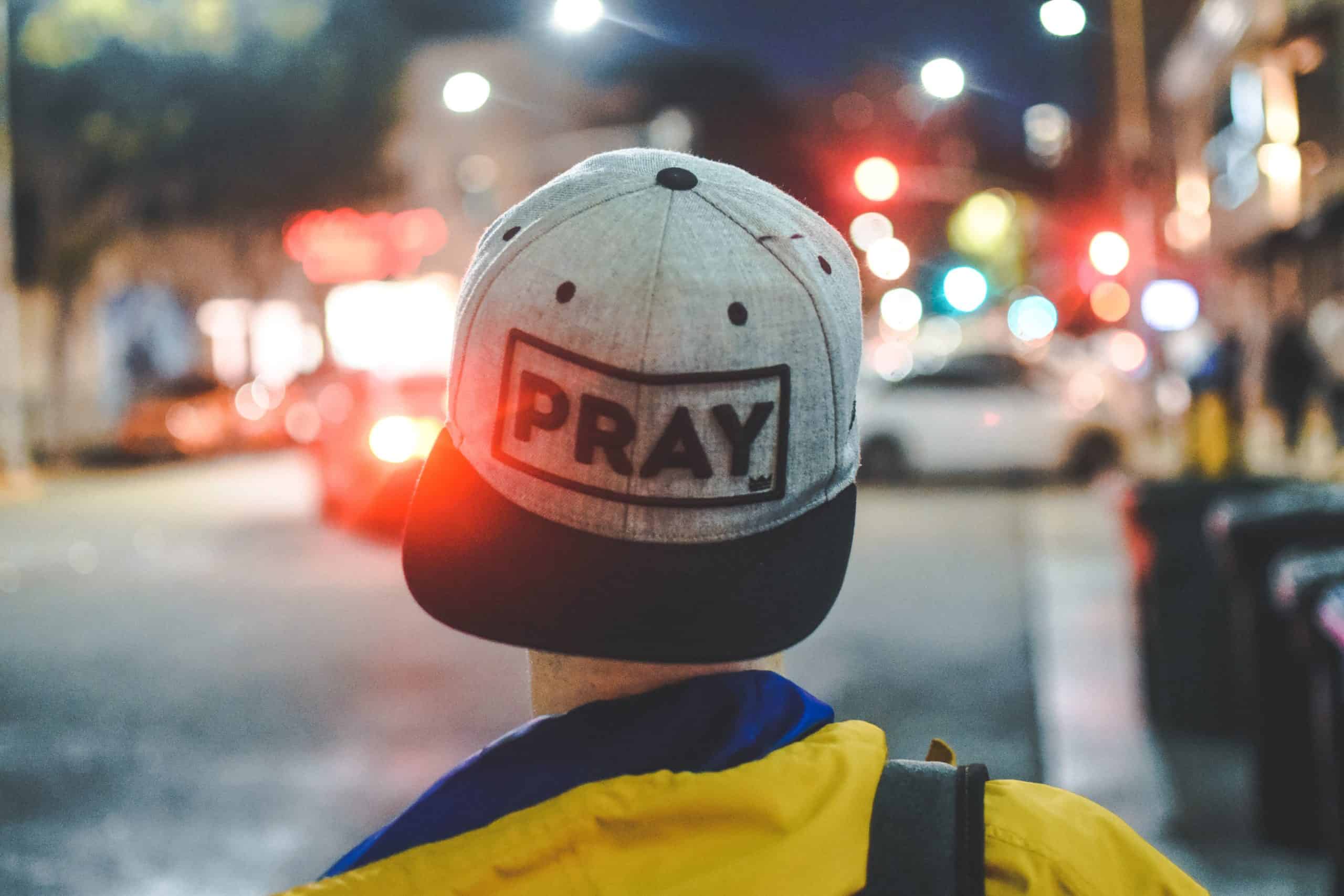 hat with the word "pray"