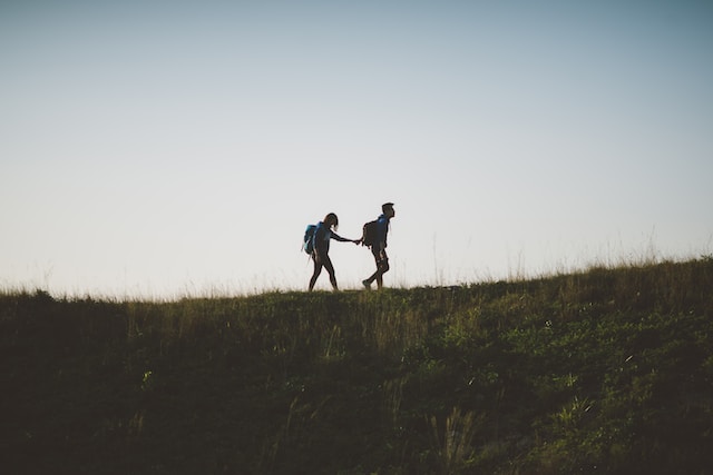 two people hiking on a ridge